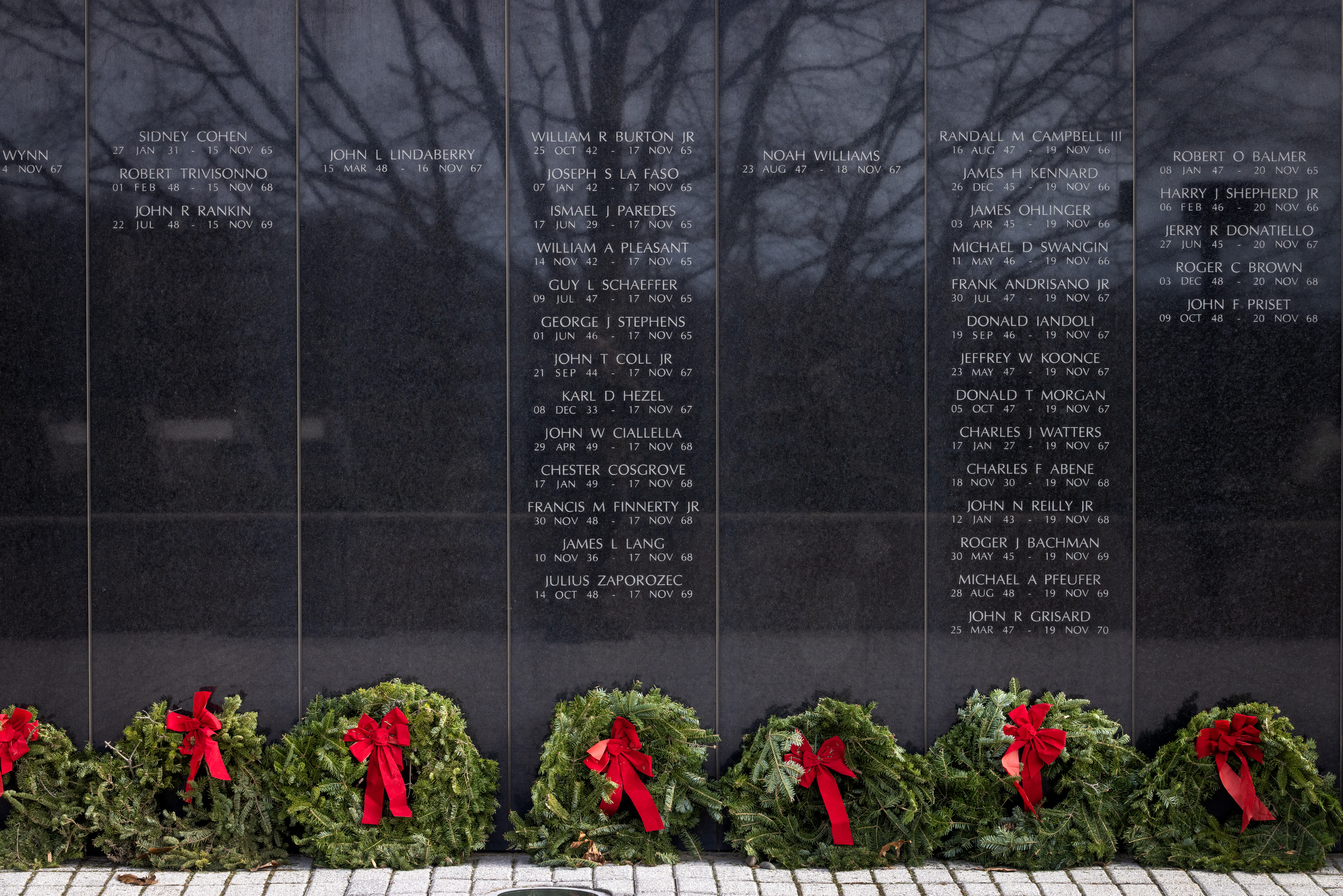 Wreaths were placed at the New Jersey Vietnam Veterans Memorial in Holmdel, New Jersey, Dec. 10, 2025. The wreaths were placed at the base of each of the memorial’s 366 eight-foot-tall black granite panels – each representing a day of the year – listing the names of the 1,564 New Jersey men and one woman who gave their lives while serving in Southeast Asia. In addition, the Wreaths Across America convoy stopped at the memorial on their annual journey to Arlington National Cemetery. This year marks the 50th anniversary of the end of the Vietnam War. (New Jersey Department of Military and Veterans Affairs photo by Mark C. Olsen)