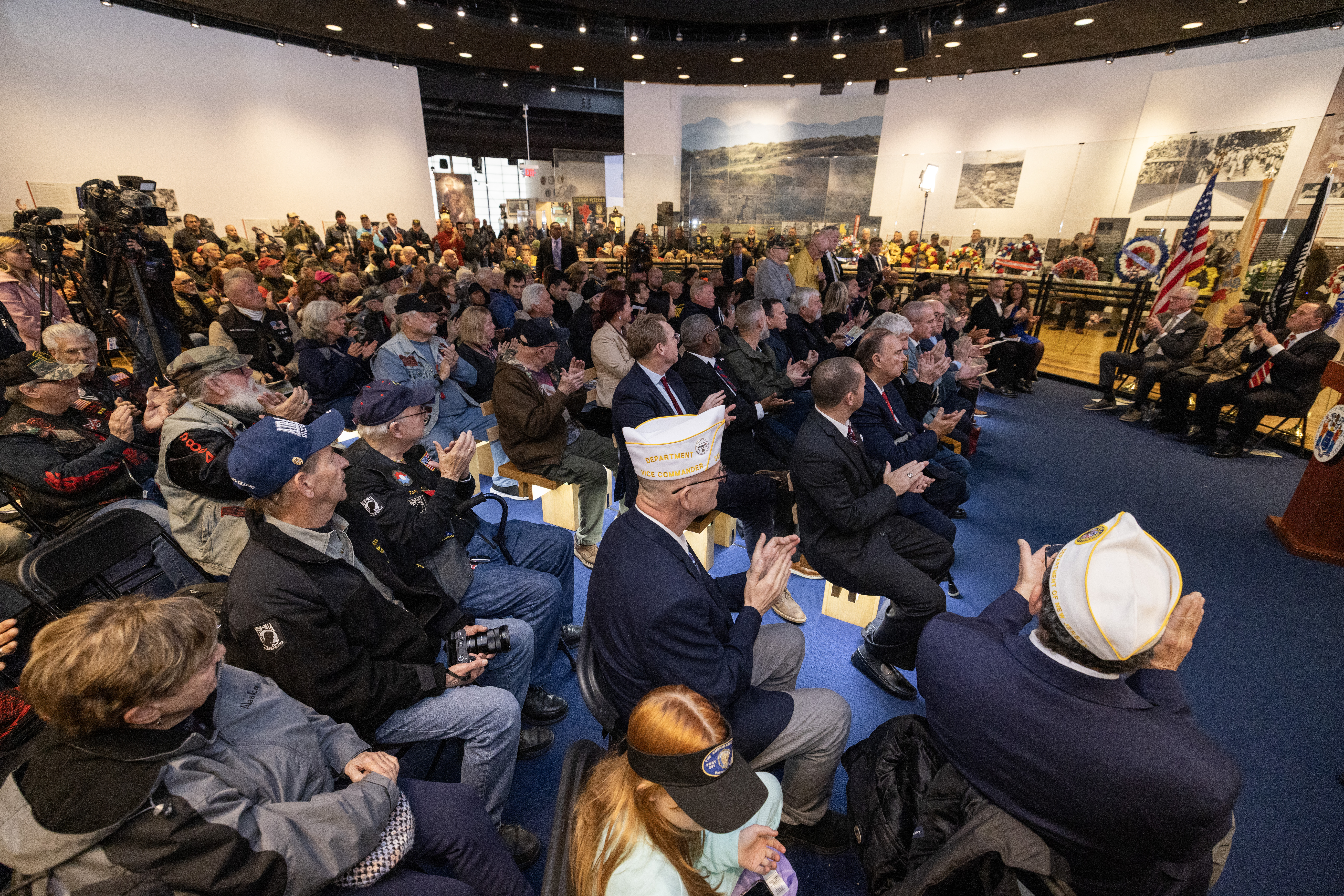 Attendees applaud during the State Veterans Day ceremony at the New Jersey Vietnam Veterans’ Memorial, Vietnam Era Museum and Educational Center at Holmdel, New Jersey, Nov. 11, 2025. Veterans Day celebrates and honors America’s veterans for their patriotism, love of country, and willingness to serve and sacrifice for the common good. (New Jersey Department of Military and Veterans Affairs photo by Mark C. Olsen)