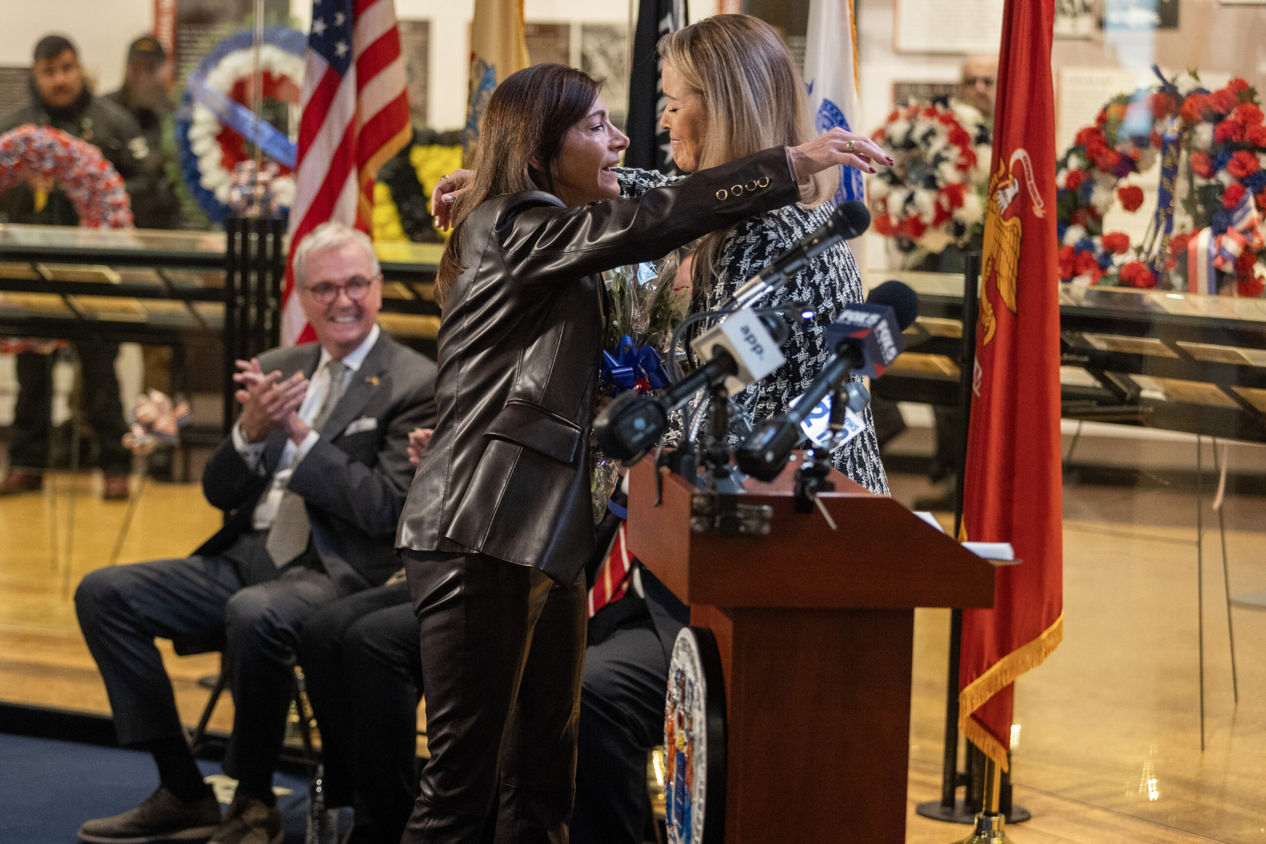 First Lady Tammy Murphy, left, is presented a bouquet of flowers during the State Veterans Day ceremony at the New Jersey Vietnam Veterans’ Memorial, Vietnam Era Museum and Educational Center at Holmdel, New Jersey, Nov. 11, 2025. Veterans Day celebrates and honors America’s veterans for their patriotism, love of country, and willingness to serve and sacrifice for the common good. (New Jersey Department of Military and Veterans Affairs photo by Mark C. Olsen)