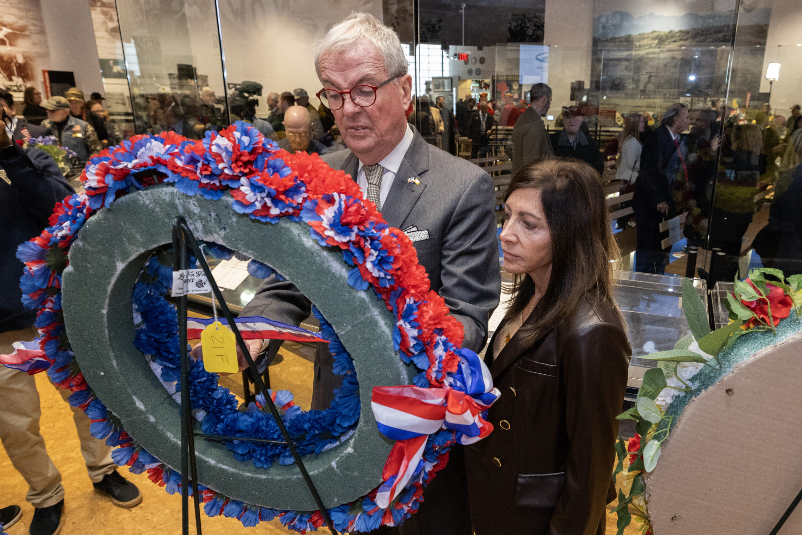 New Jersey Gov. Philip D. Murphy, left, and First Lady Tammy Murphy review the wreaths after the State Veterans Day ceremony at the New Jersey Vietnam Veterans’ Memorial, Vietnam Era Museum and Educational Center at Holmdel, New Jersey, Nov. 11, 2025. Veterans Day celebrates and honors America’s veterans for their patriotism, love of country, and willingness to serve and sacrifice for the common good. (New Jersey Department of Military and Veterans Affairs photo by Mark C. Olsen)